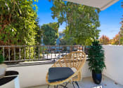 Thumbnail 5 of 95 - a balcony with a rattan chair and a plant on it