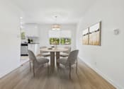 Thumbnail 2 of 28 - A dining room with a table and chairs.