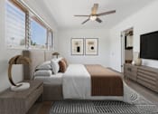 Thumbnail 7 of 28 - A bedroom with a bed, a bench, and a ceiling fan.