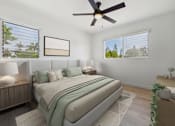 Thumbnail 8 of 28 - A bedroom with a large bed and a ceiling fan.