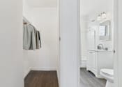 Thumbnail 3 of 19 - A white bathroom with a toilet, sink, and a mirror.
