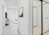 Thumbnail 11 of 61 - A hallway with a white door and a framed picture on the wall.