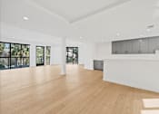 Thumbnail 77 of 119 - A spacious room with wooden floors and white walls.