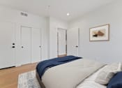 Thumbnail 50 of 157 - A bedroom with a bed, pillows, and a painting on the wall.