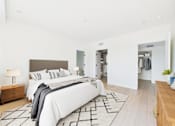 Thumbnail 42 of 157 - A large bedroom with a large bed and a wooden bench.