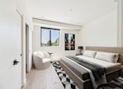 Thumbnail 39 of 157 - A modern bedroom with a large bed and a chair.
