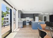 Thumbnail 30 of 157 - A modern kitchen with a dining table and chairs.