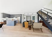 Thumbnail 33 of 157 - A modern kitchen with a dining table and chairs.