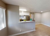Thumbnail 29 of 34 - A kitchen area with a counter and a refrigerator.