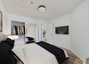 Thumbnail 4 of 38 - A bedroom with a bed and a wardrobe.