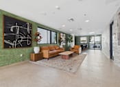 Thumbnail 16 of 33 - A living room with a green wall and a large abstract painting.
