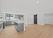 Thumbnail 79 of 119 - A modern kitchen with wooden floors and stainless steel appliances.