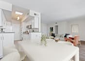 Thumbnail 2 of 18 - a living room and kitchen with a white table