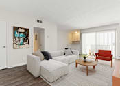 Thumbnail 5 of 18 - a living room with a couch and a coffee table