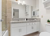 Thumbnail 10 of 18 - a bathroom with a sink and a toilet and a shower