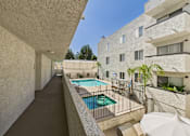Thumbnail 55 of 60 - A long hallway with a pool on the other side.