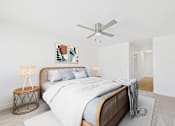 Thumbnail 5 of 19 - A bedroom with a large bed and a ceiling fan.