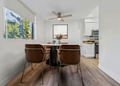 Thumbnail 3 of 29 - A dining room with a table and chairs.