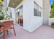 Thumbnail 7 of 29 - A patio with a chair and a table.