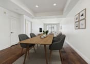 Thumbnail 4 of 88 - A dining room with a wooden table and chairs.