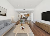 Thumbnail 5 of 88 - A modern living room with a grey sofa and a wooden coffee table.