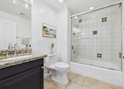 Thumbnail 11 of 88 - A bathroom with a toilet, sink, and shower.
