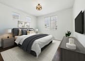 Thumbnail 7 of 88 - A bedroom with a large bed and a flat screen TV mounted on the wall.