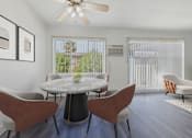 Thumbnail 13 of 30 - A dining room with a round table and chairs.