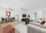 Thumbnail 6 of 30 - A living room with a white couch and a coffee table.