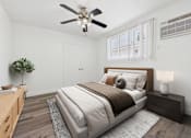 Thumbnail 8 of 30 - A bedroom with a large bed, a ceiling fan, and a nightstand with a lamp.