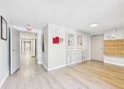 Thumbnail 12 of 15 - A hallway with a white exit sign above the door.