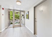 Thumbnail 11 of 15 - A hallway with a door numbered 101 on the right.