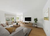 Thumbnail 2 of 15 - A living room with a grey couch and a wooden coffee table.