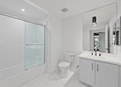 Thumbnail 84 of 119 - A white bathroom with a toilet, sink, and shower.