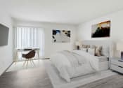 Thumbnail 4 of 17 - a bedroom with a bed and a desk and a tv