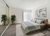 Thumbnail 3 of 17 - a bedroom with a bed and a large mirror