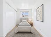 Thumbnail 9 of 12 - A bedroom with a bed, a window, and a picture on the wall.