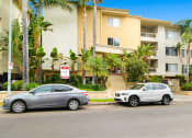 Thumbnail 11 of 12 - two cars parked in front of an apartment building