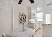 Thumbnail 4 of 21 - A white marble table with a vase on it in a kitchen.