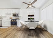 Thumbnail 3 of 78 - A modern kitchen with a dining table set for four.