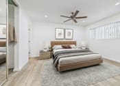 Thumbnail 8 of 78 - A bedroom with a large bed and a ceiling fan.