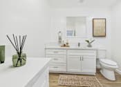 Thumbnail 10 of 78 - A white bathroom with a vanity and a toilet.