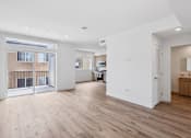 Thumbnail 57 of 69 - A spacious room with wooden flooring and white walls.
