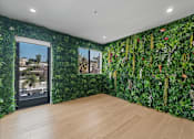 Thumbnail 72 of 119 - A room with a green wallpaper and a wooden floor.