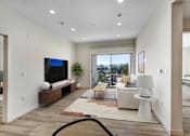 Thumbnail 3 of 90 - A modern living room with a flat screen TV and a view of the outdoors.