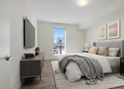 Thumbnail 5 of 90 - A bedroom with a bed, a dresser, and a window overlooking a cityscape.