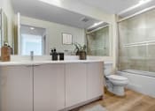 Thumbnail 10 of 90 - A white toilet sits next to a bathtub in a bathroom.