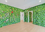 Thumbnail 71 of 119 - A room with a green wallpaper of plants and flowers.
