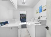 Thumbnail 26 of 26 - a laundry room with washing machines and other appliances