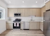 Thumbnail 54 of 69 - A modern kitchen with wooden cabinets and stainless steel appliances.